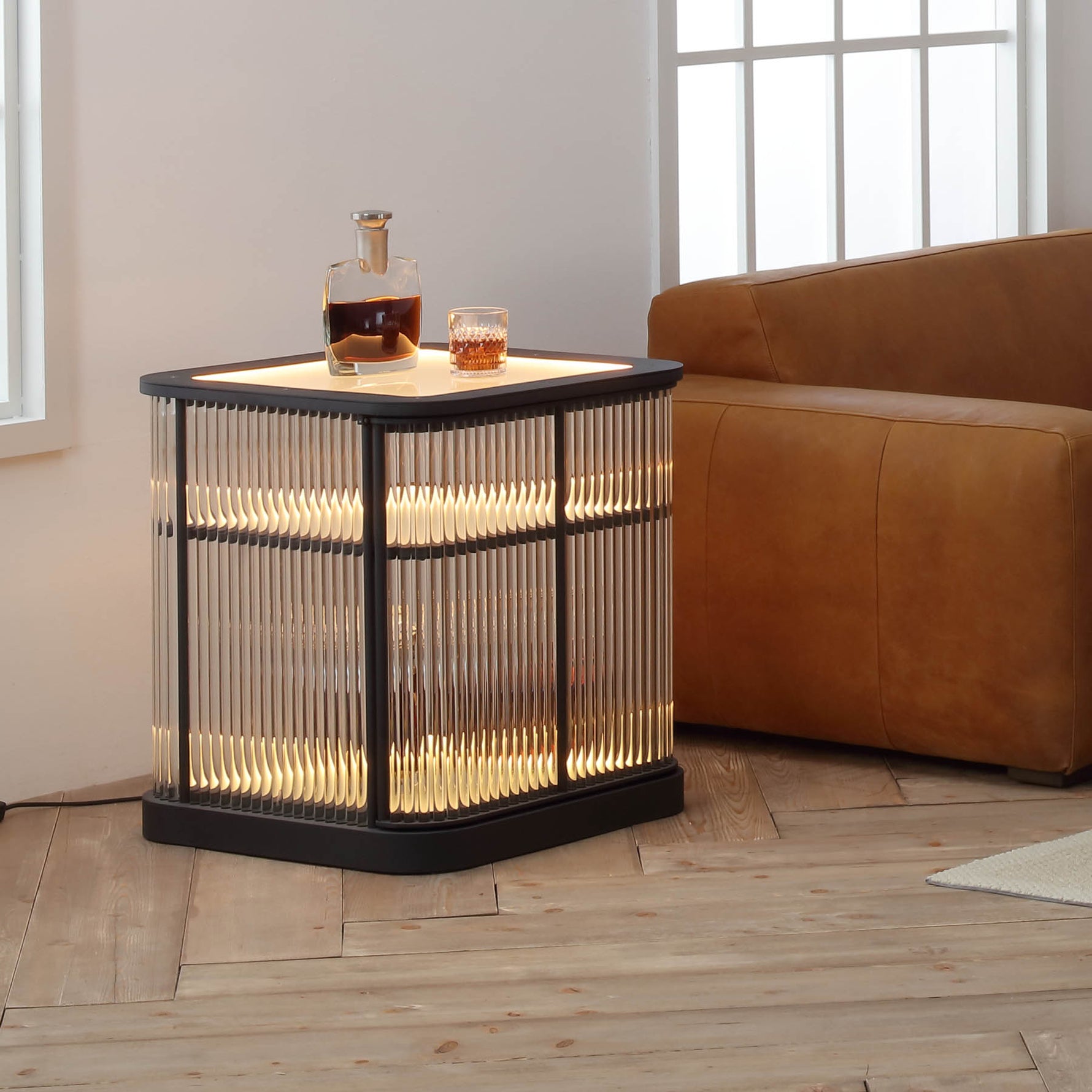 lifestyle view of LED bar cabinet with brass detailing and left-hand hinged door on living room background