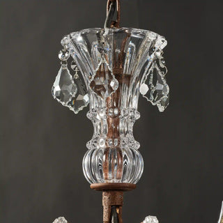 Unlit Moorizon Rustline 12-light crystal chandelier close-up with faceted crystal column, metal frame details, and hanging crystal accents on a dark background
