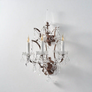 Unlit Moorizon Rustline 3-light wall sconce with curved iron arms, candle sleeves, and cascading crystal accents on a white background