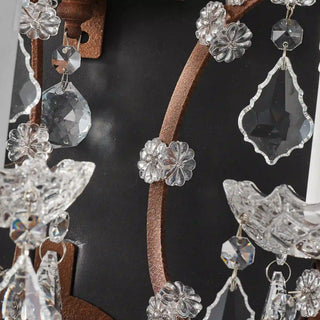 Unlit Moorizon Rustline 3-light wall sconce detail showing faceted crystal strands, antique-style metal arms, and dark background