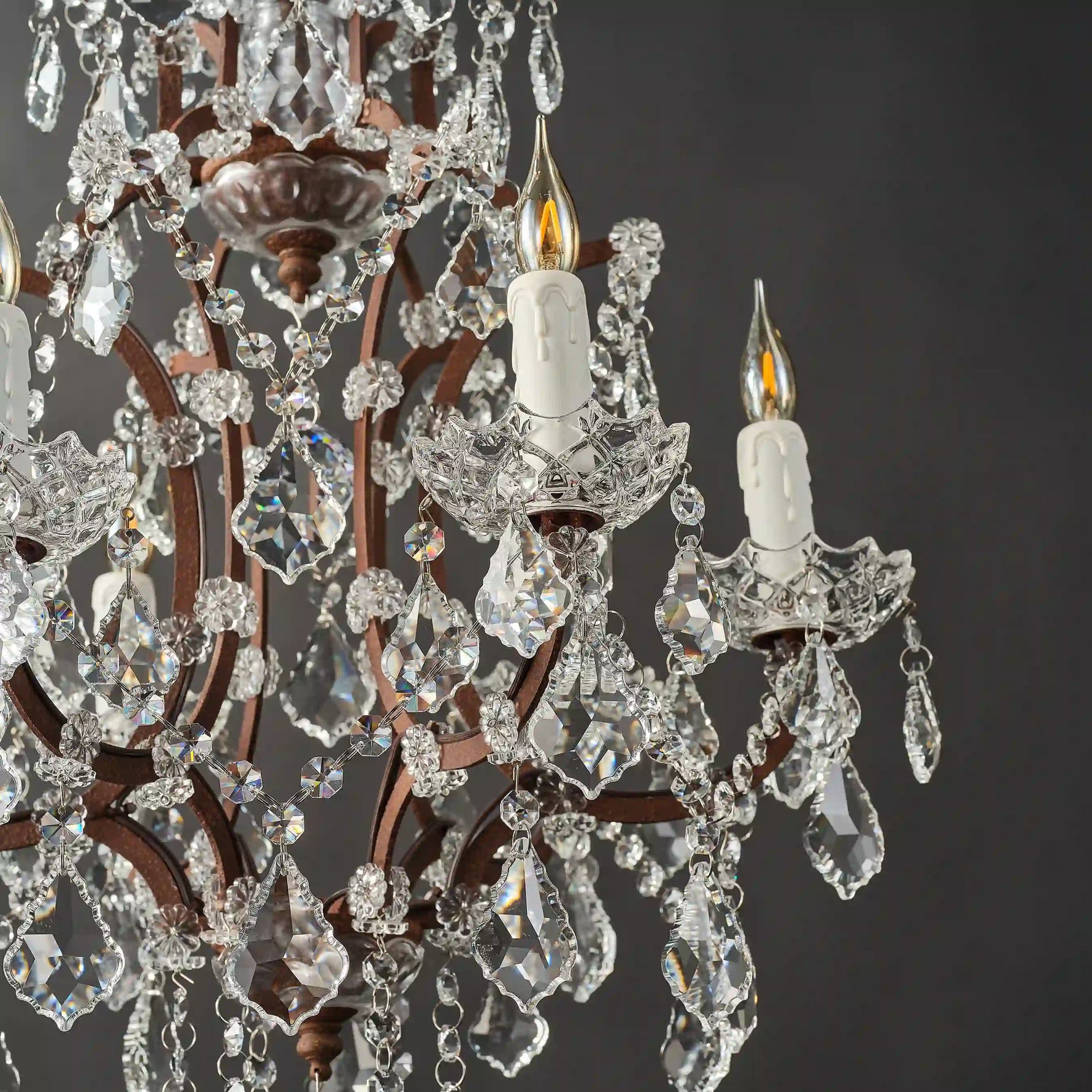 Moorizon Rustline 6-light crystal chandelier with layered crystals and candle-style bulbs, black background detail view, unlit