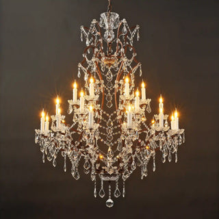 Moorizon Rustline 25-light crystal chandelier with warm candle lights, ornate iron frame, and cascading crystals, black background lit view