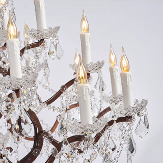 Warmly lit Moorizon Rustline 25-light crystal chandelier detail with candle-style bulbs, ornate iron arms, and faceted crystal accents on a white background