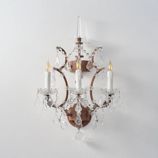 Unlit Moorizon Rustline 3-light wall sconce with ornate iron arms, candle sleeves, and crystal drops on a white background