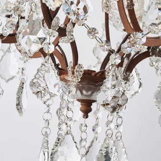 Unlit Moorizon Rustline 6-light crystal chandelier detail showing ornate iron arms, crystal strands, and hanging crystal drops on a white background