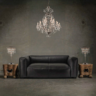 Moorizon Rustline crystal chandelier — cascading crystal tiers over dark sofa, moody living room scene