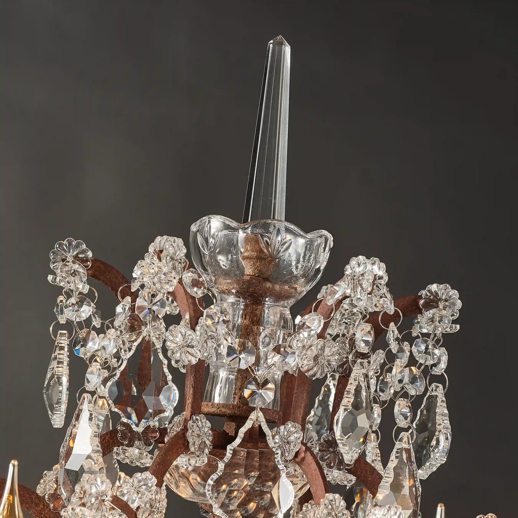 Rustline crystal floor lamp detail with faceted crystal pendants and rusted metal accents in black background. 