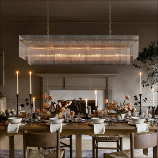MOORIZON Timelore Rectangle Chandelier, Large – elongated ribbed-glass linear chandelier in a dining room scene with candles and flowers decor