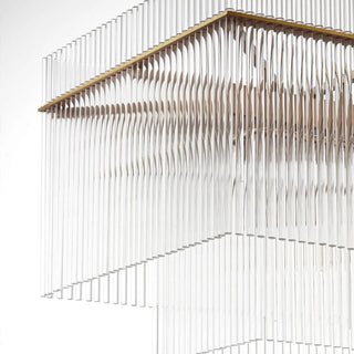 Unlit Timelore Rectangular Chandelier detail on a white background, showing layered rows of individual clear glass rods set into a brass frame. 