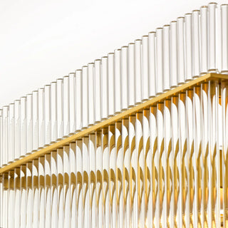 Close-up of the Timelore Rectangular Chandelier showing individual glass rods aligned beneath a warm brass frame in a white background. 