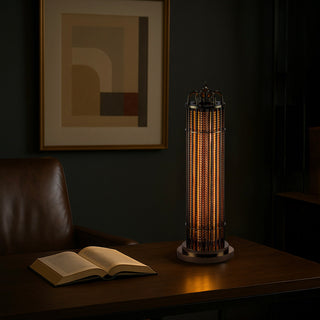 Urban Glow table lamp glowing softly in a dark, sophisticated space, placed beside a book on a wooden table