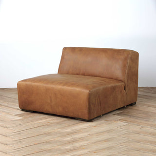 Rustic Haven armless sectional seat in cocoa brown leather, wood floor background