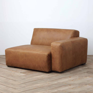 Rustic Haven left arm sectional sofa piece in cognac brown leather, wood floor background