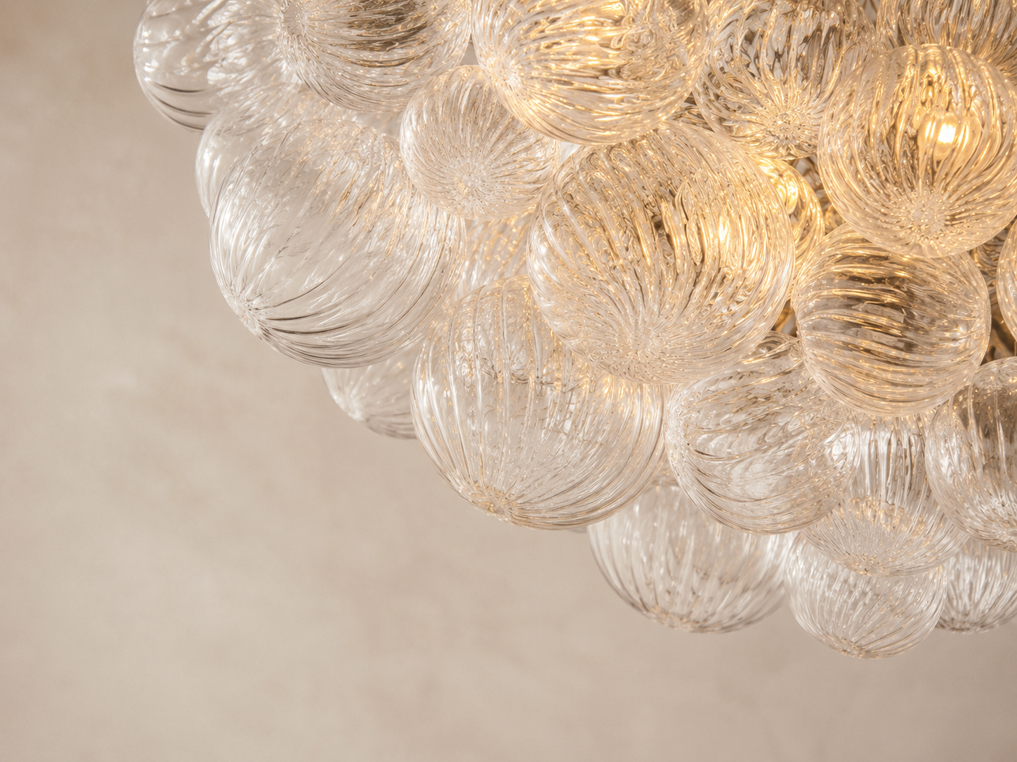 Detailed view of layered spiral bubble glass with individually formed curves and translucent handcrafted texture.