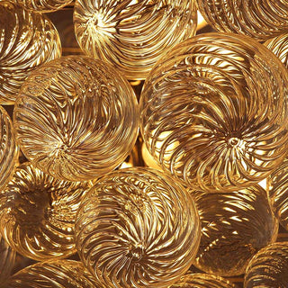 detail view of golden lumious hand-blown spiral glass globes wih ripple pattern in art deco modern design