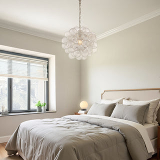 spiral bubble glass pendant and moonlit table lamp styled in modern bedroom interior