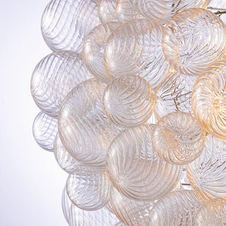 detail view lumious hand-blown spiral glass orbs wih ripple pattern in art deco modern design