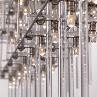 close-up detail of stardust chandelier focusing on warm lighting, glass rod texture and polished metal reflections