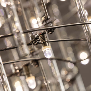 Close-up of Stardust chandelier detail showing warm lighting, illuminated glass rods and reflective surfaces