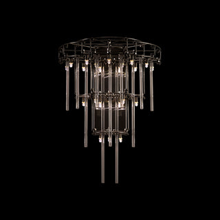 Small Stardust Sconce Lamp glowing dramatically in a dark setting, highlighting its sculptural form and cascading glass rods