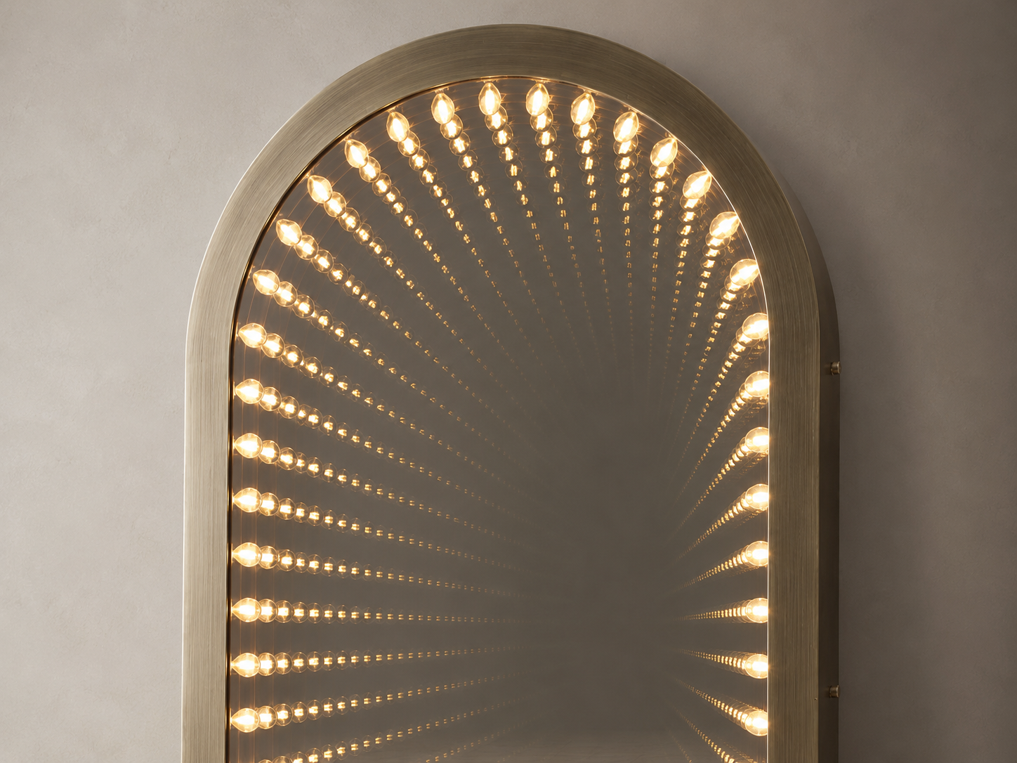 Close-up of the Timeless Gate arched mirror with radiating warm LED illumination
