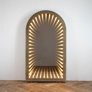 front view of timeless gate oversized arched mirror with LED infinity lighting effect on wood floor