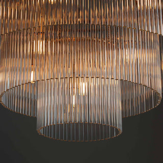 close-up of timelore tiered chandelier showcasing finely textured crystal rods and brushed brass frame