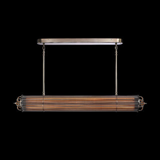 front view Low-light image of Urban Glow dining lamp with glowing amber glass and polished metal accents