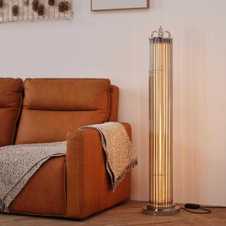 Urban Glow floor lamp softly illuminating a cozy living room, placed beside a modern tan sofa in a warm, ambient setting
