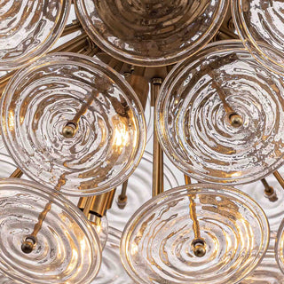 Wavora Demi flush mount with layered rippled glass discs and brass frame.