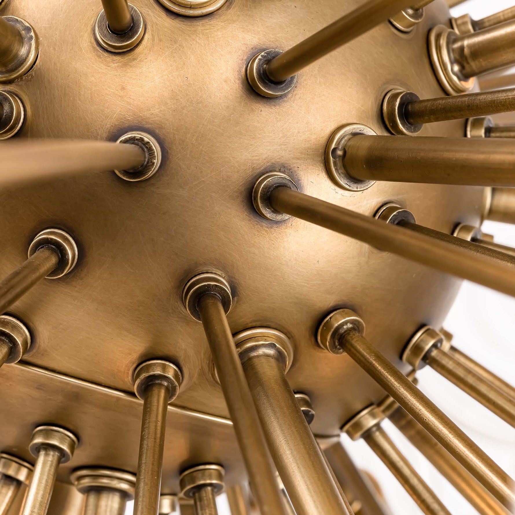 Close-up of Wavora Demi flush mount brass inner structure and sputnik metal rod details