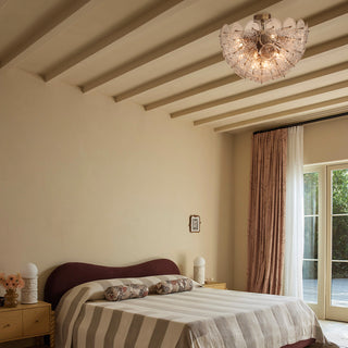 Wavora demi flushmount ceiling light installed in neutral bedroom, modern glass flower fixture over bed